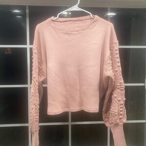 Pink Boho sweater with textured crochet arms in a crop fit